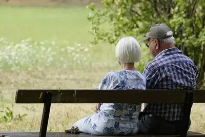 Elderly couple sitting together on a bench